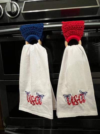 Embroidered tea towels with wood ring crocheted hangers.